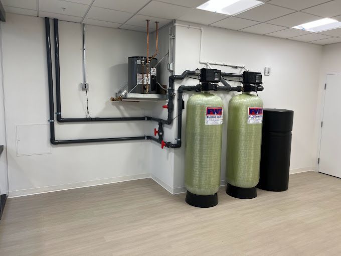 Two water filters are sitting in a room next to each other.