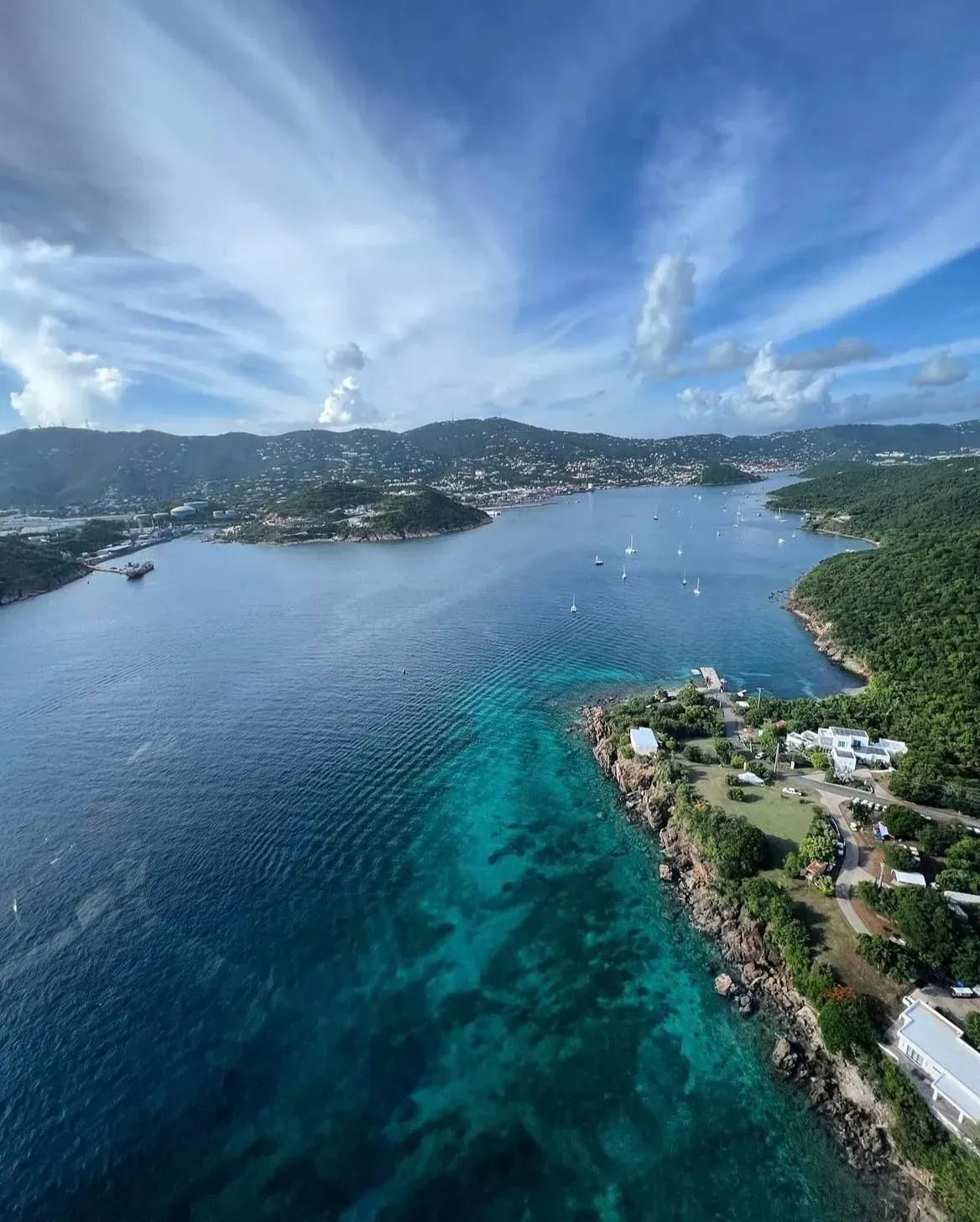 An aerial view of a large body of water with mountains in the background.
