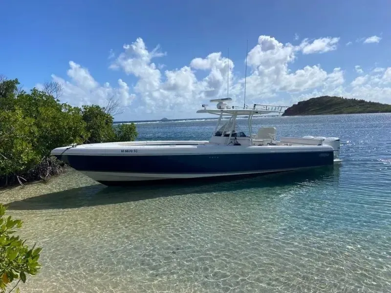 A boat is docked on the shore of a body of water.
