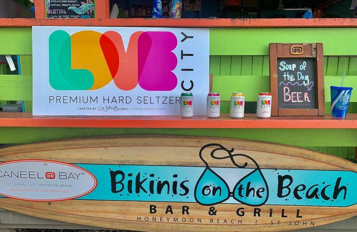A sign for bikinis on the beach bar and grill