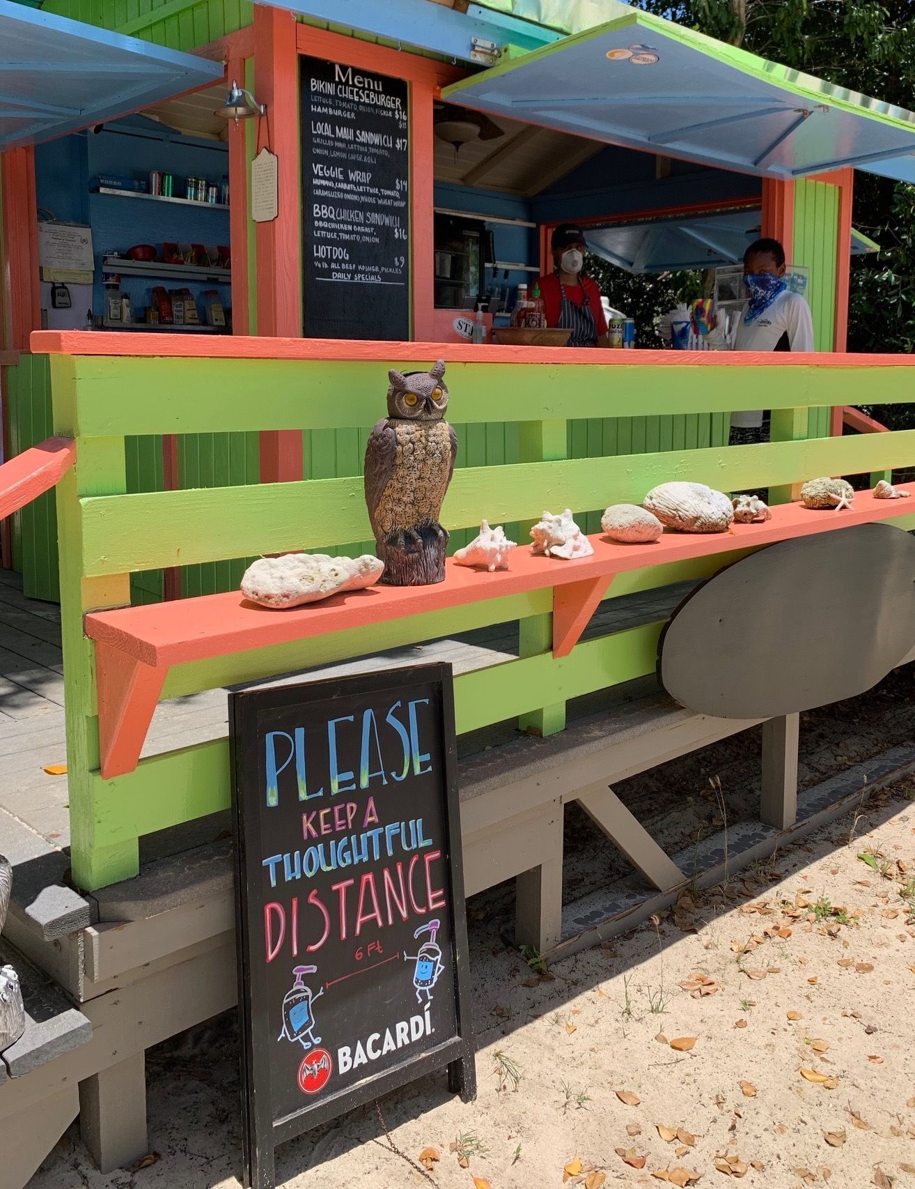 A restaurant with a sign that says please keep a thoughtful distance