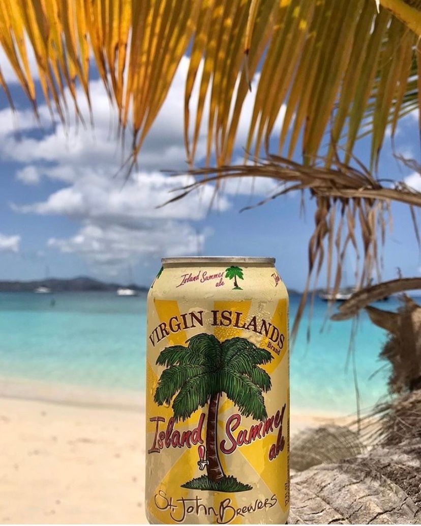 A can of virgin island beer is sitting on the beach
