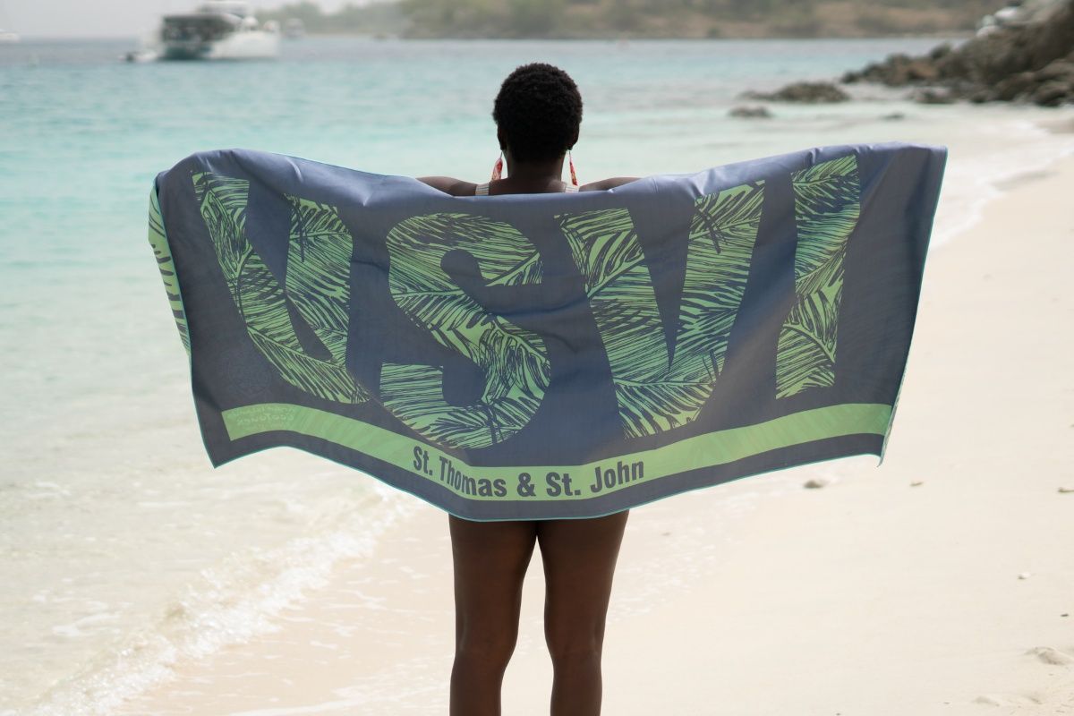 A woman is holding a towel that says usv on it