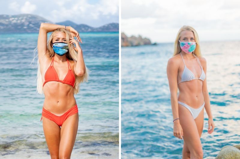 A woman in a bikini is wearing a face mask on the beach.