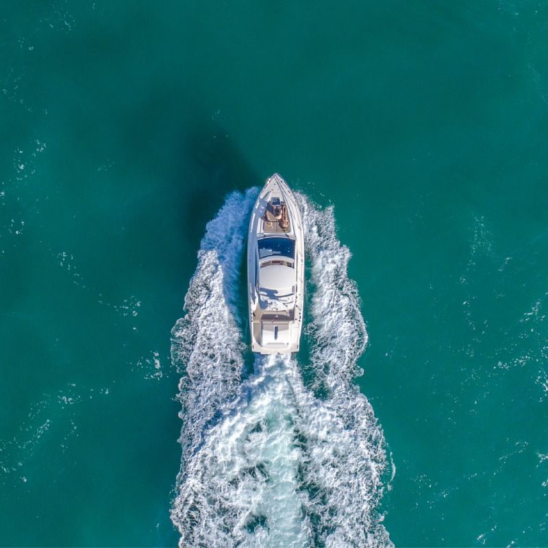 An aerial view of a boat floating on top of a body of water.