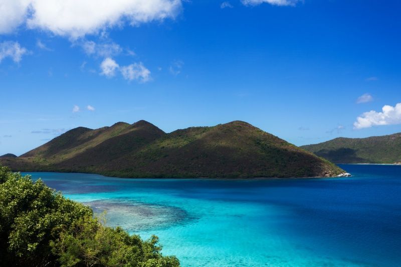 There are mountains in the background and a large body of water in the foreground.