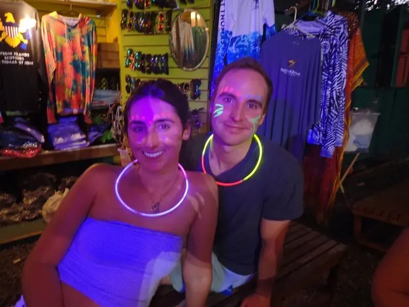 A man and a woman are in a kayak at night