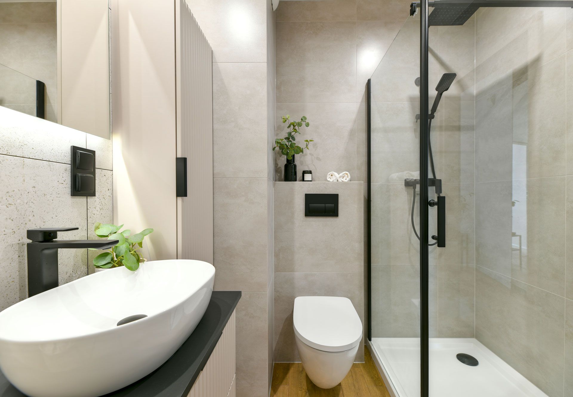 A bathroom with a sink , toilet and shower.