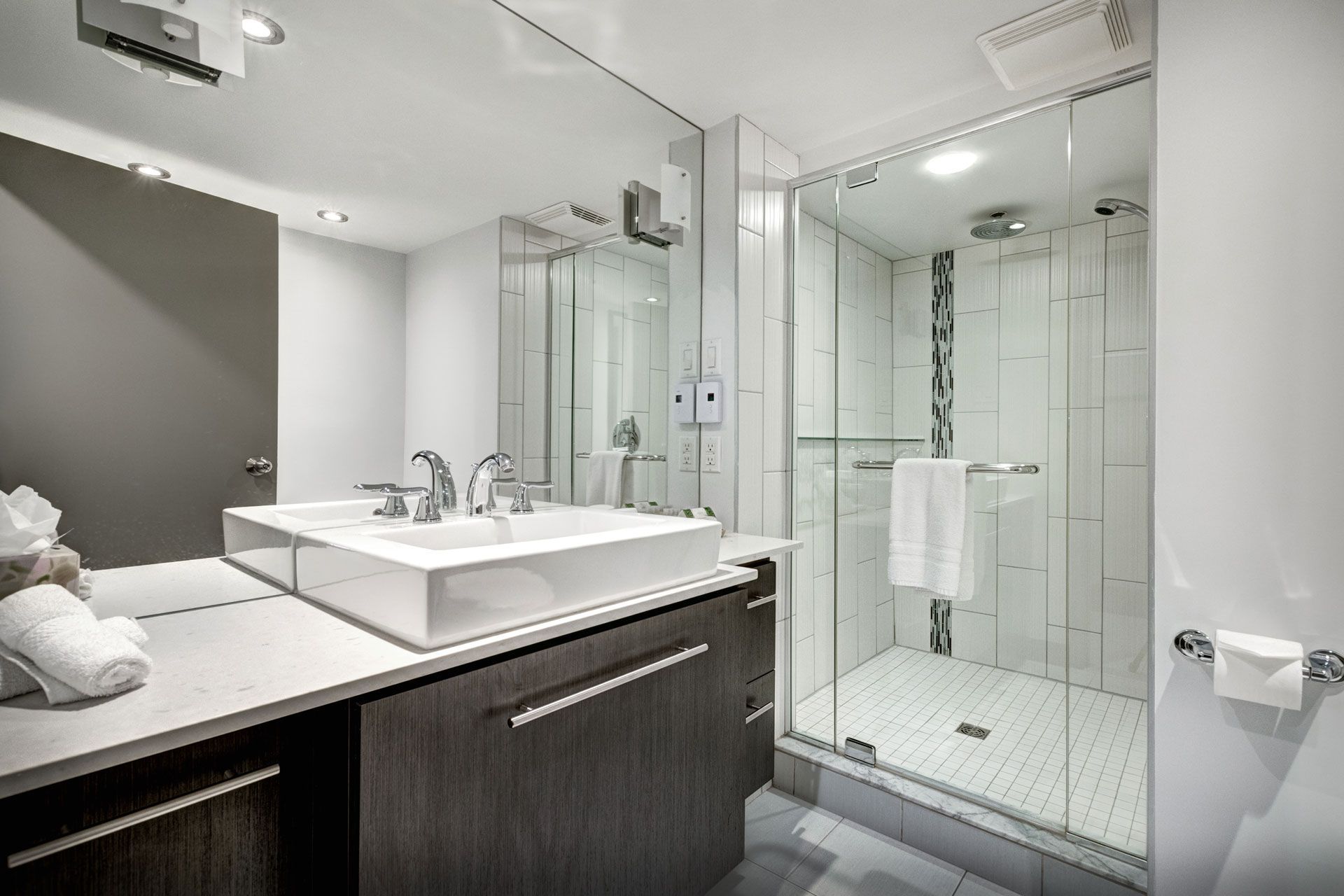 A bathroom with a sink and a walk in shower