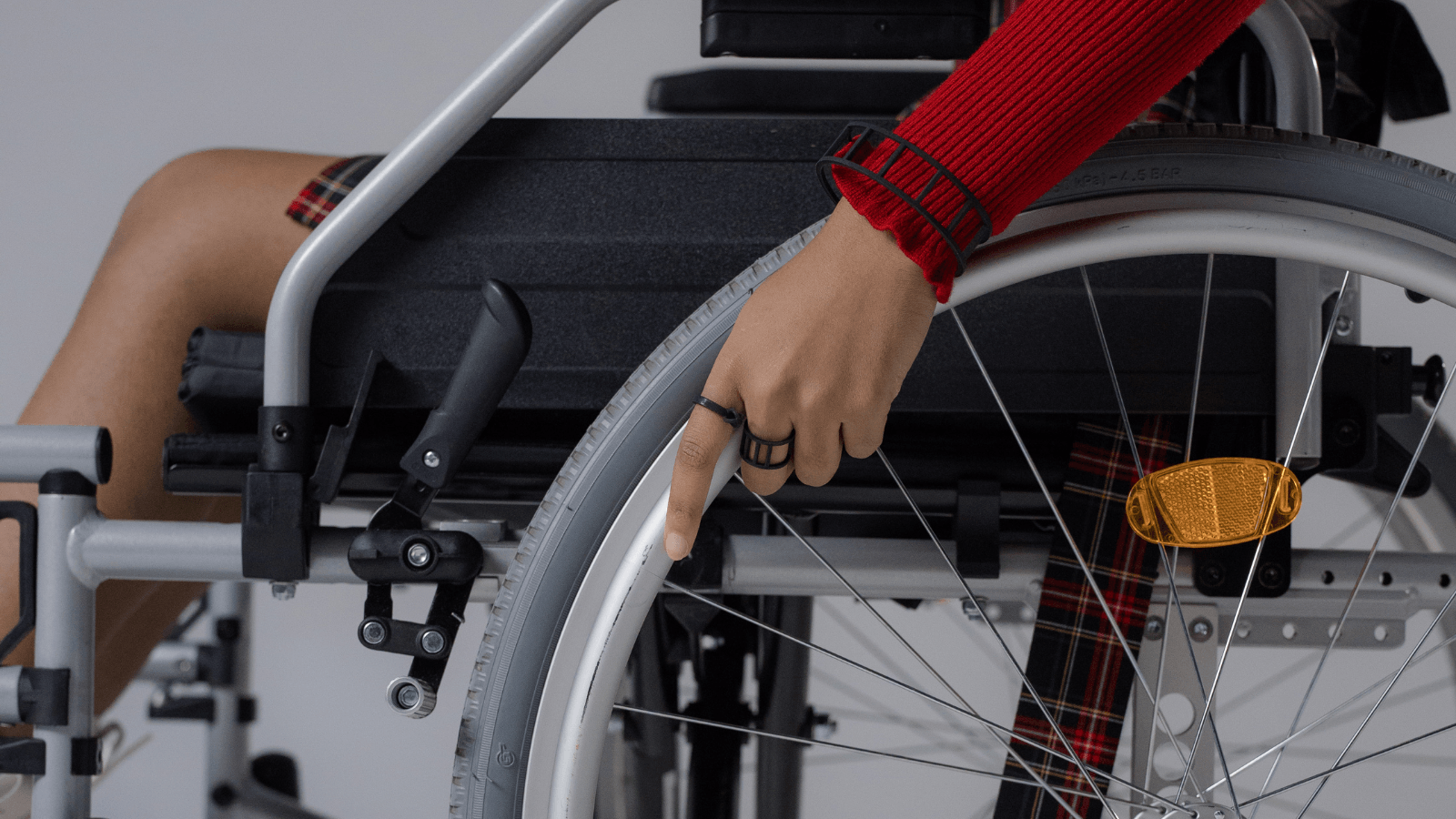 A person in a wheelchair with a ring on their finger