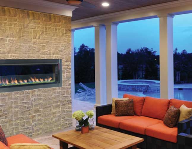 A living room with a couch , table and fireplace.