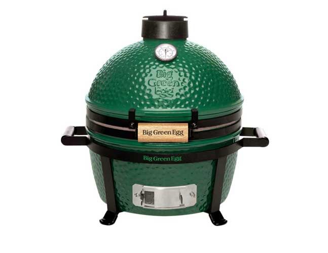 A green big green egg grill on a white background