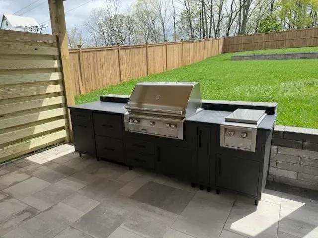 A fire pit is sitting next to a swimming pool.