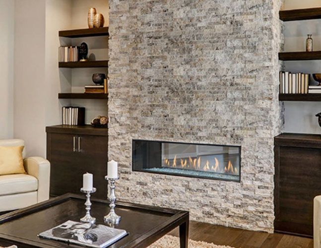 A living room with a fireplace and a coffee table.