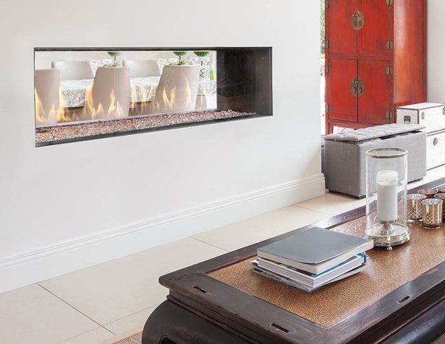 A living room with a fireplace and a coffee table.