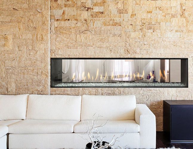A living room with a fireplace and a white couch