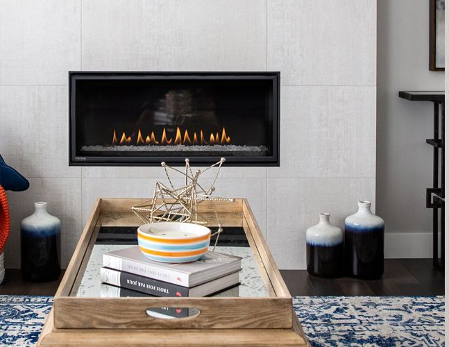 A living room with a fireplace and a coffee table