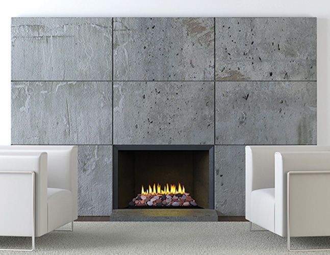 A living room with two white chairs and a fireplace.