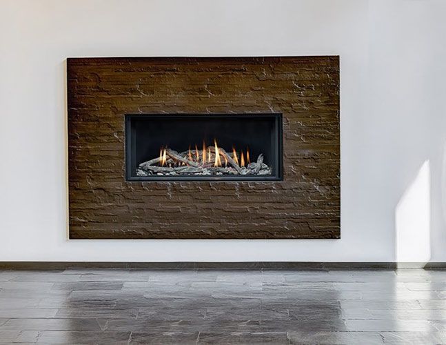 A fireplace is built into a brick wall in a living room.