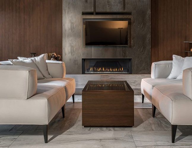 A living room with two couches and a fireplace.