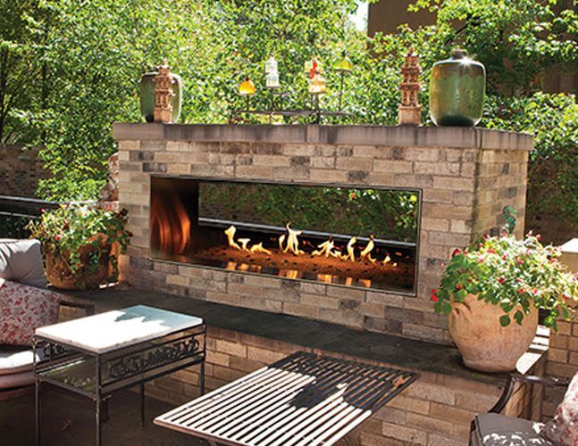 There is a fireplace in the middle of the patio.