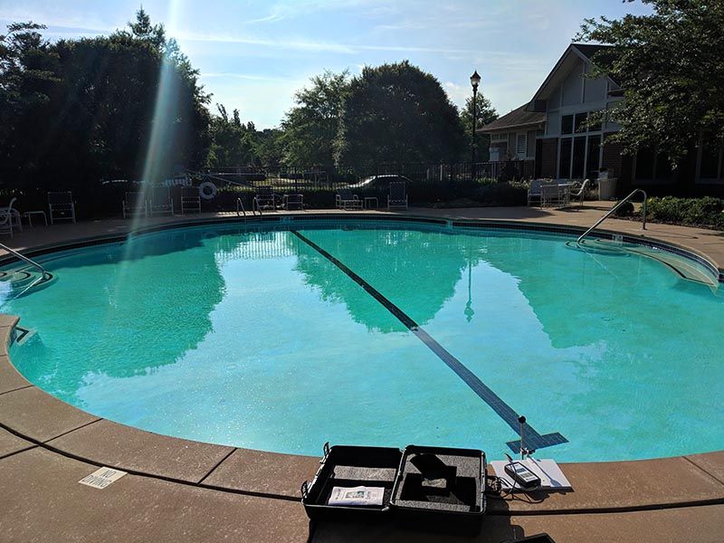 A large swimming pool with a toolbox on the edge