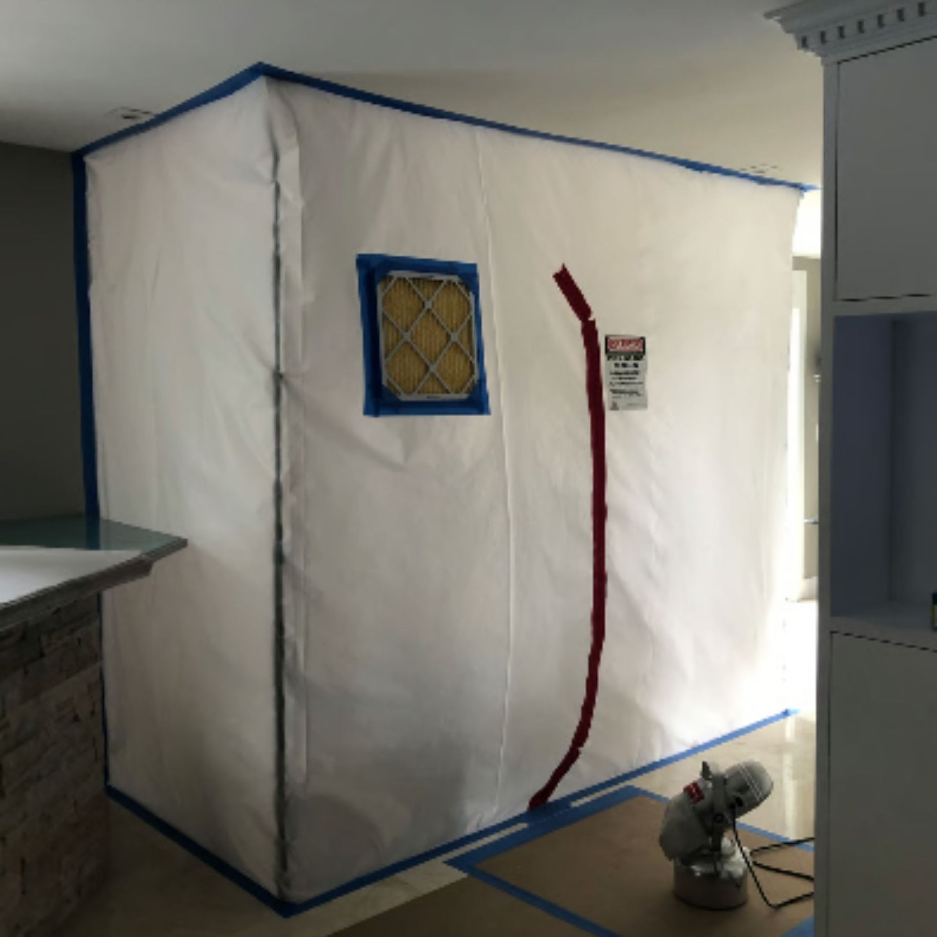 Mold Remediation Inc -A room with a warning sign on the wall