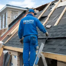 Roofer in blue uniform with