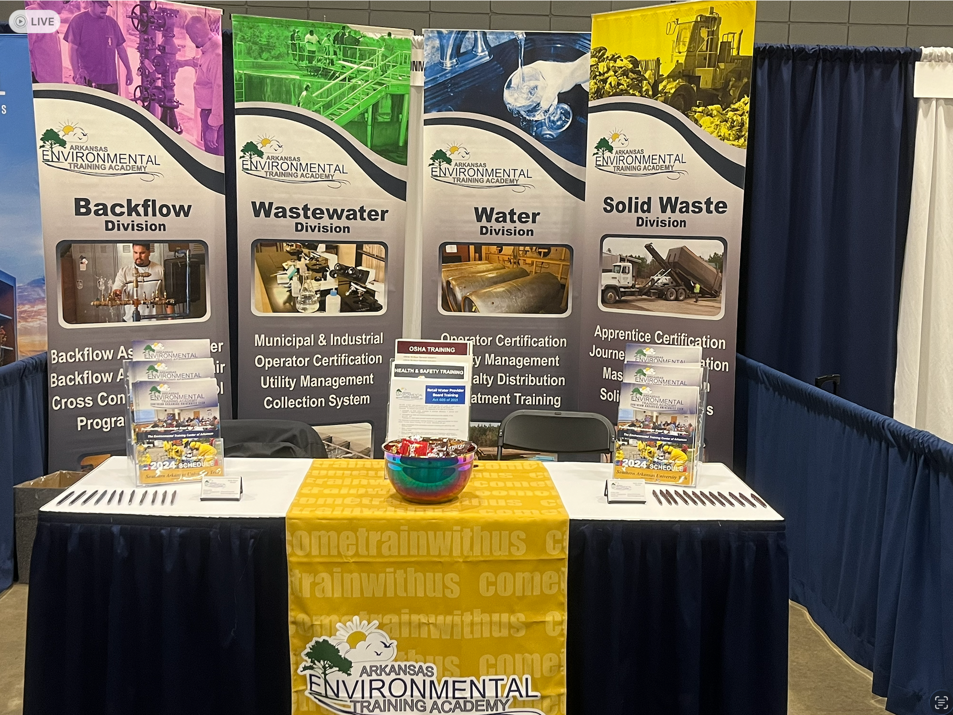 Environmental waste-management booth with four poster banners and two display tables