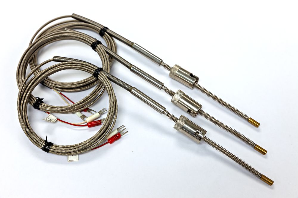 Black-and-silver electronic component with two long metal leads on a white background