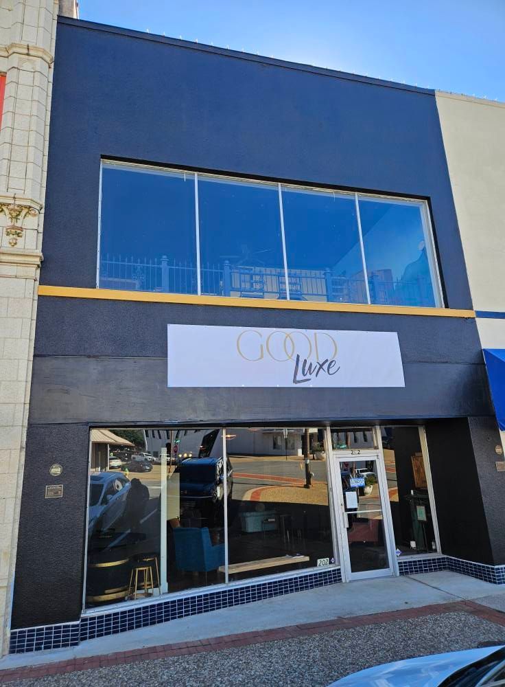 Black storefront with large windows; 