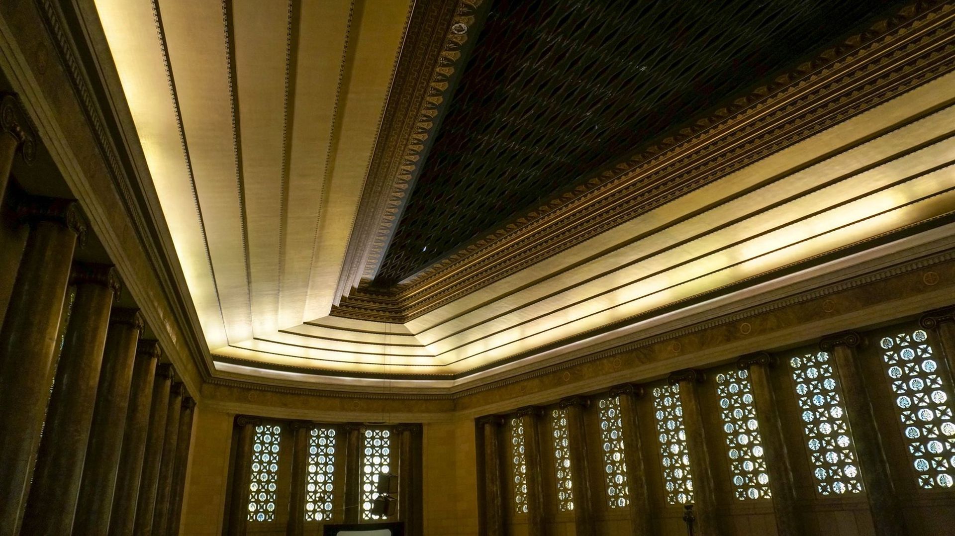 Looking up at the ceiling of a building with a lot of windows