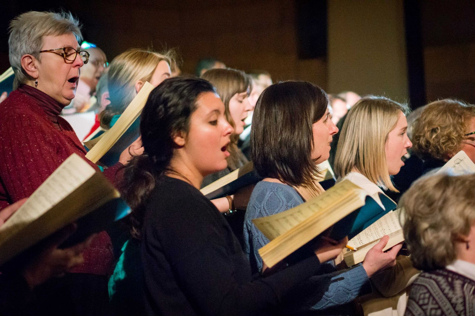 A group of people are singing together in a choir.