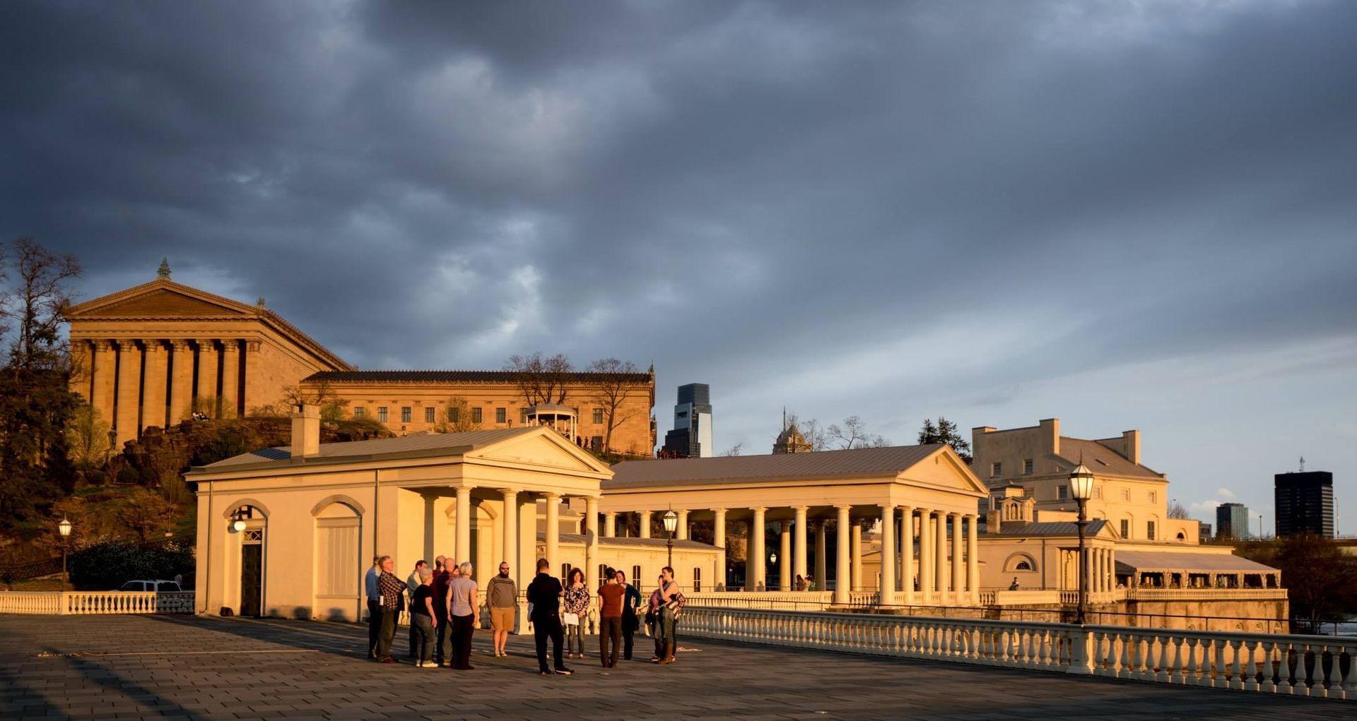 A group of people are standing in front of a large building.