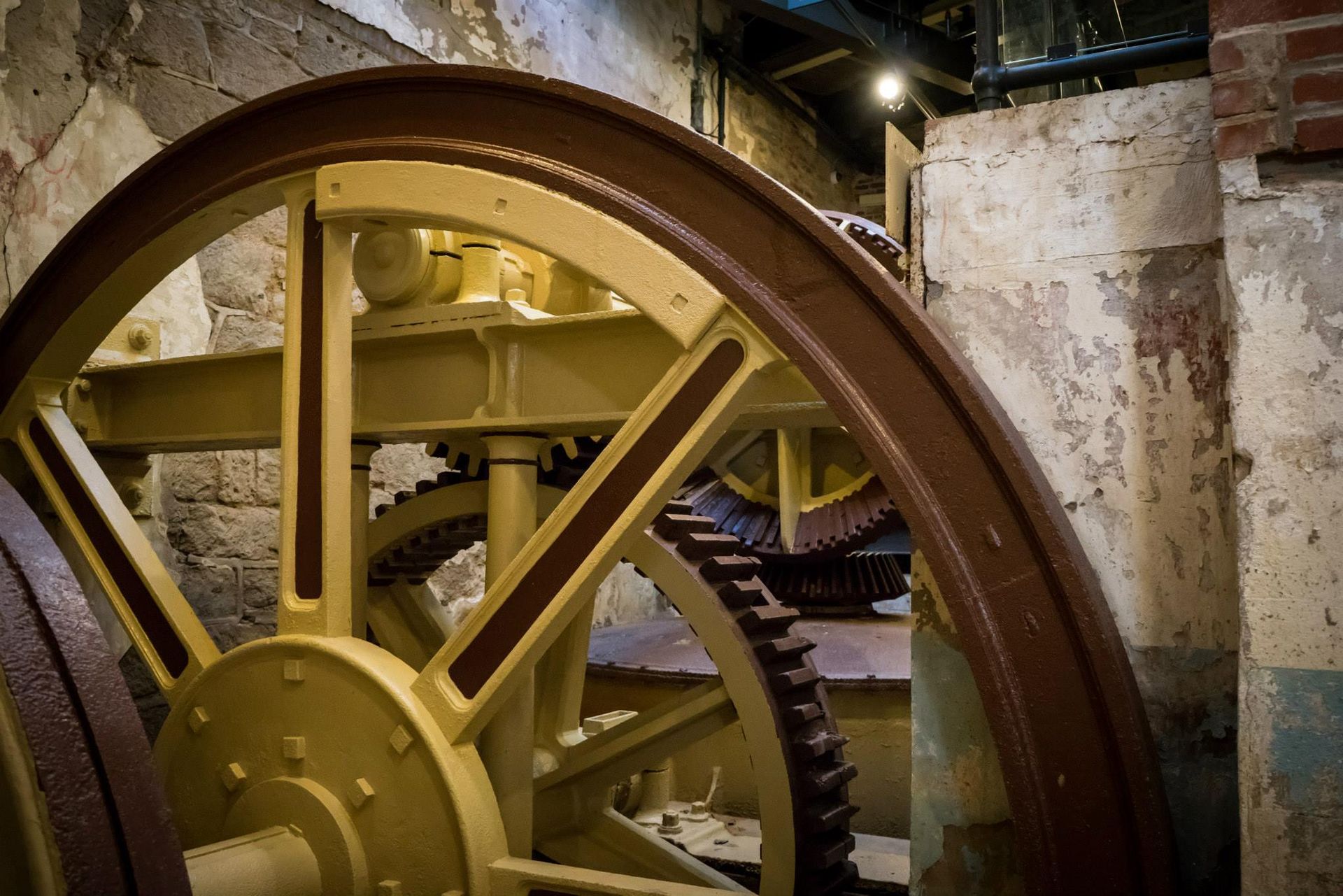 A close up of a wheel with a brick wall in the background