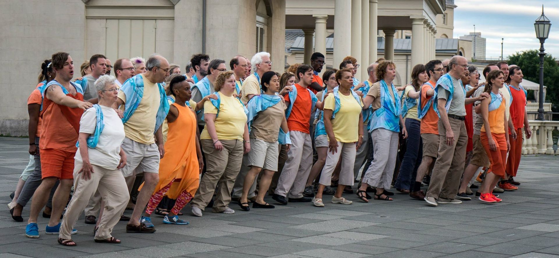 A large group of people are standing in front of a building.