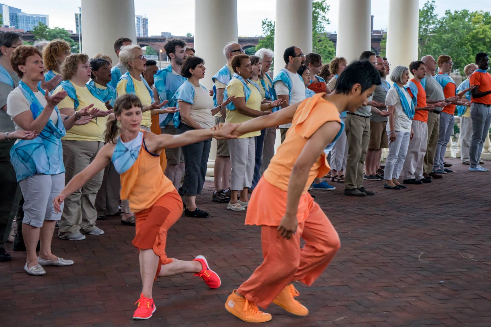 A man and a woman are dancing in front of a crowd of people