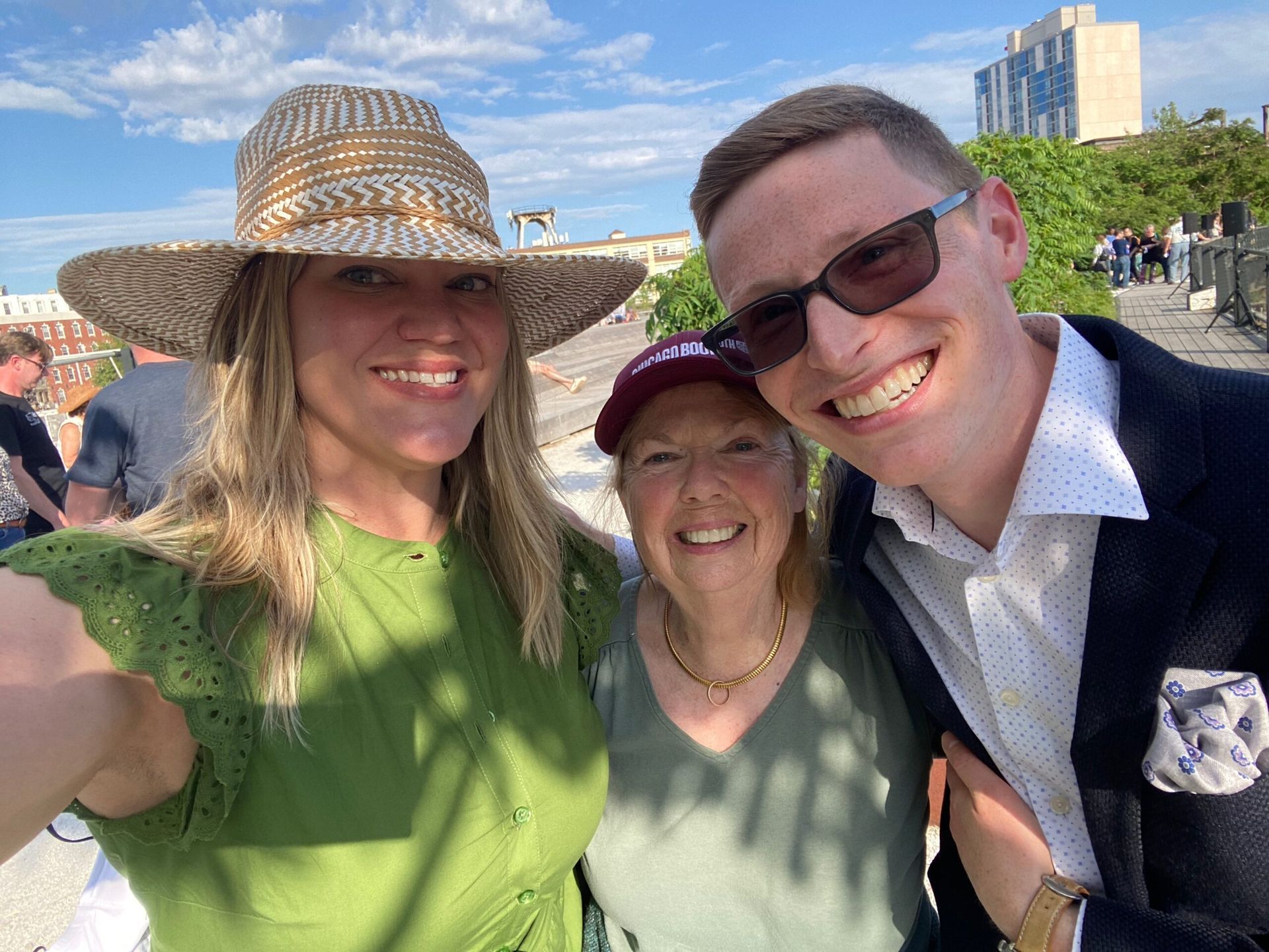 A man and two women are posing for a picture together.
