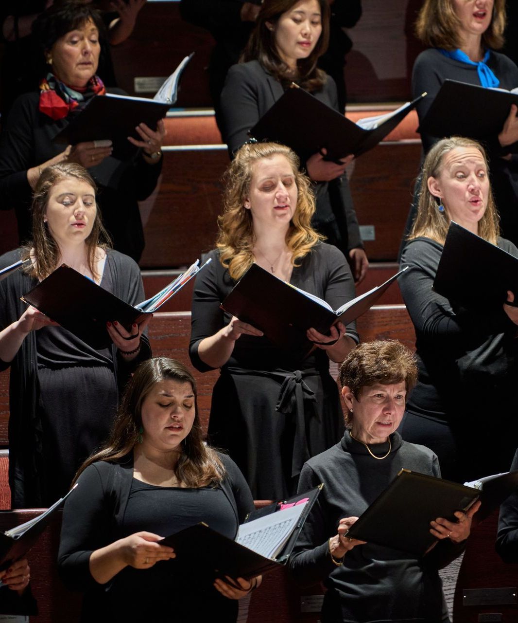 A group of women are singing together in a choir