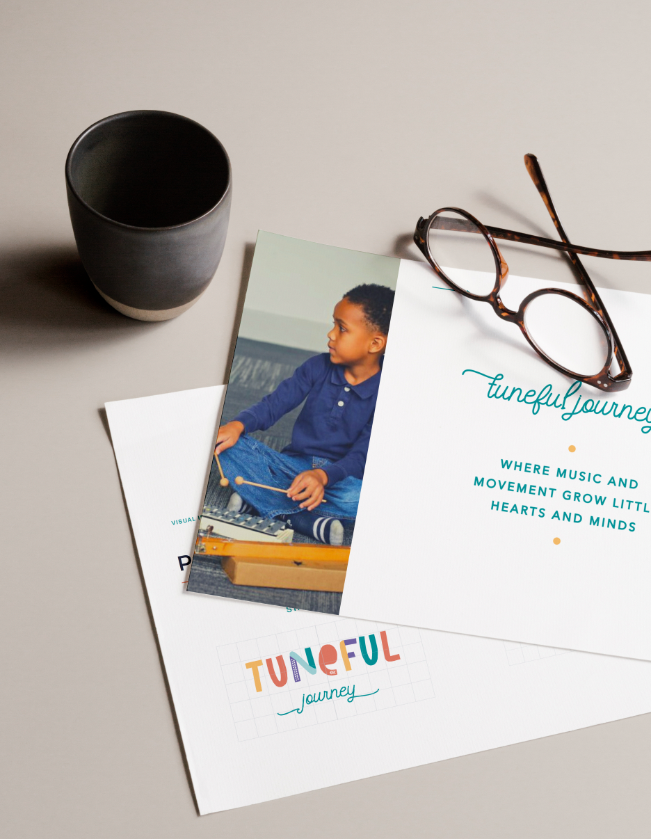 A book with a picture of a child sitting on a table next to a cup and glasses.