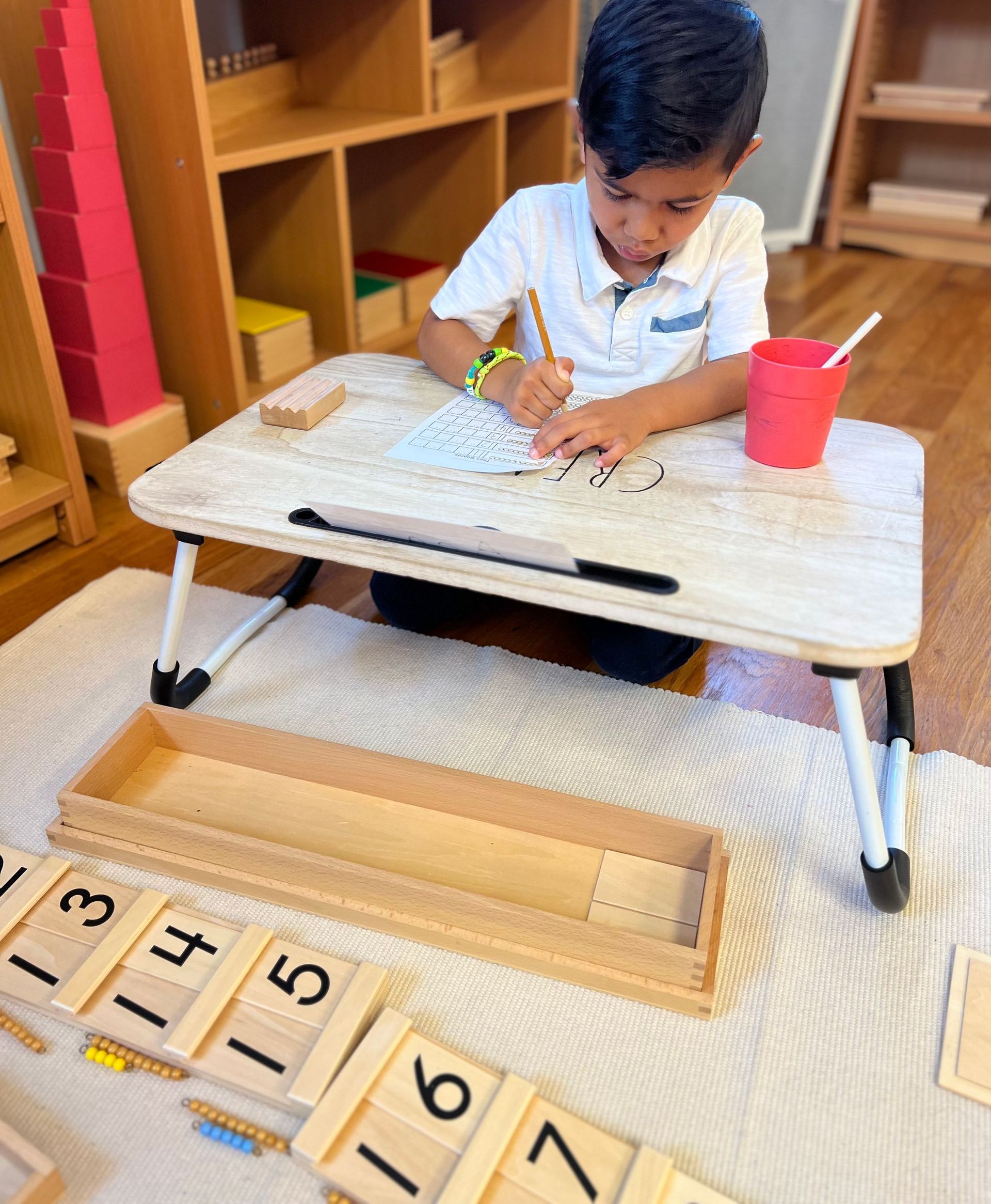 Montessori child working with math materials