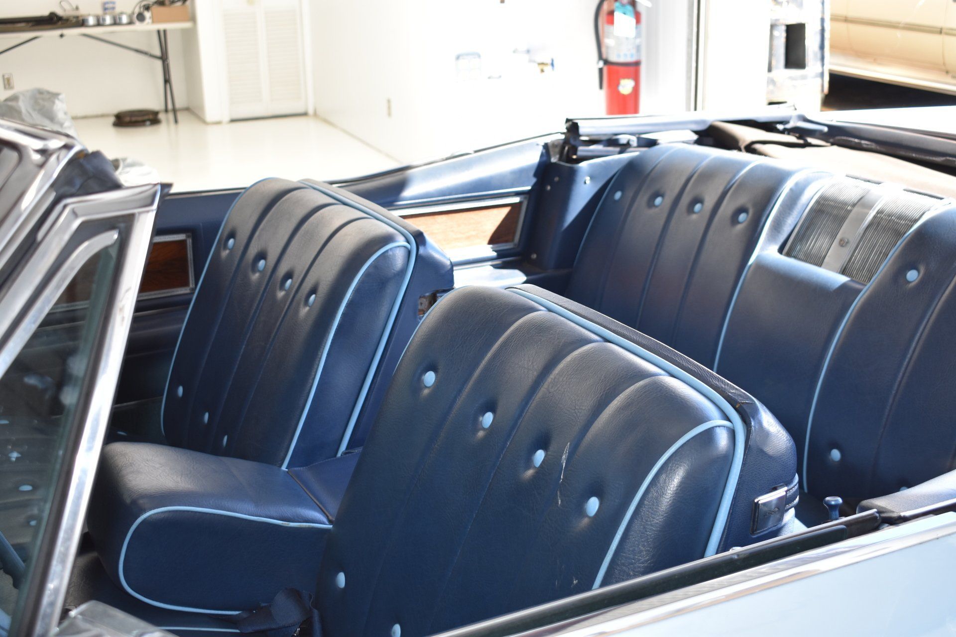 Blue vinyl car seats in an open-top classic car interior