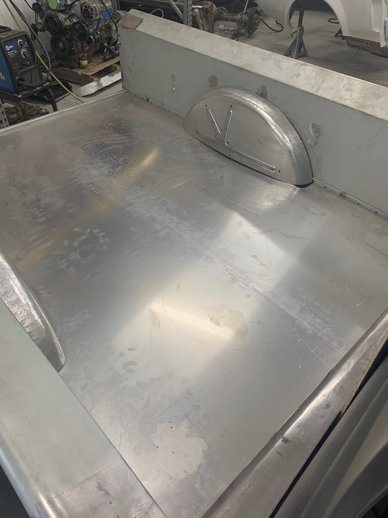 Silver industrial metal surface with a semicircular handle and gray walls around it