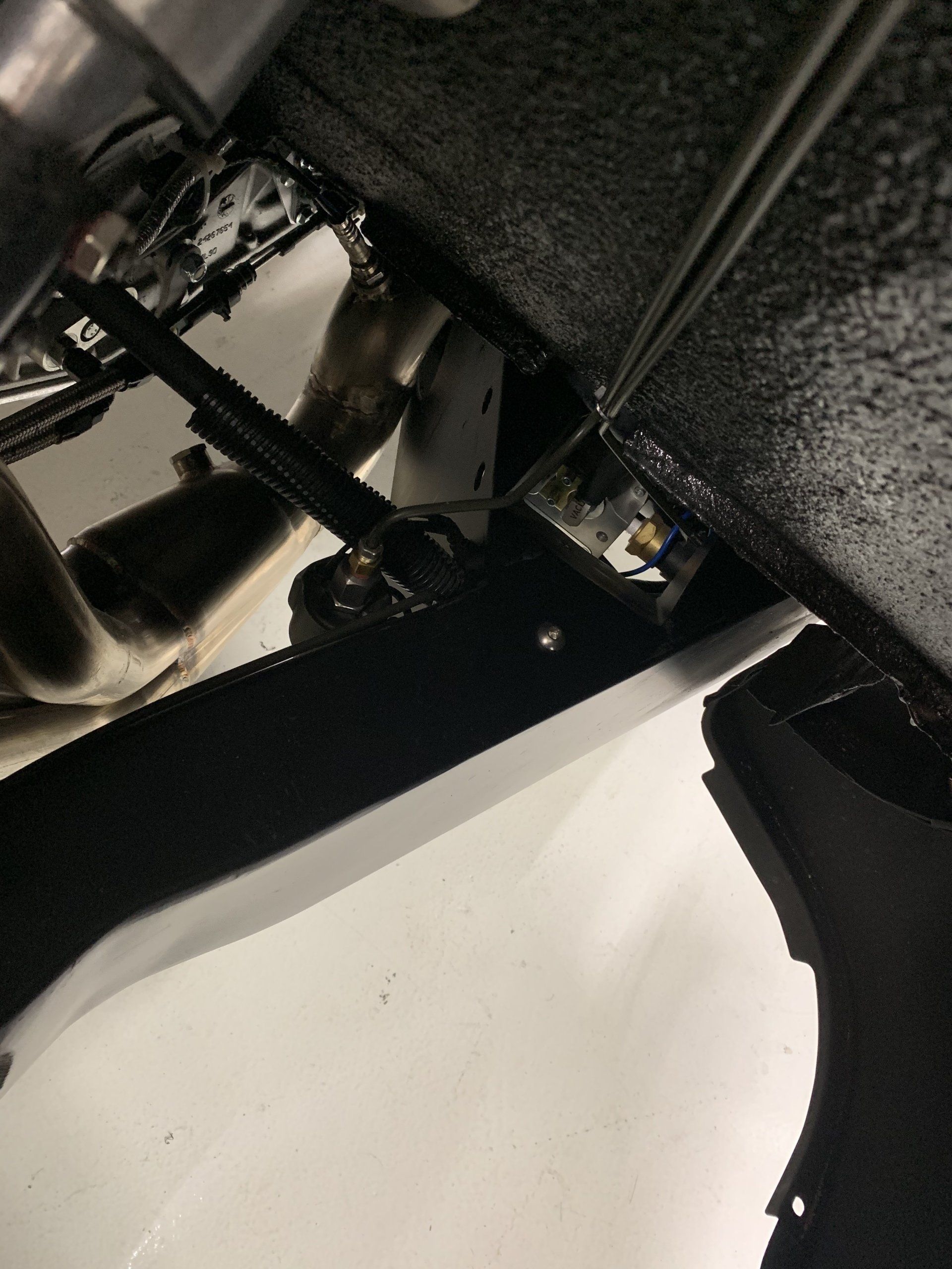 Close-up of a black mechanical part and white surface on a textured gray background