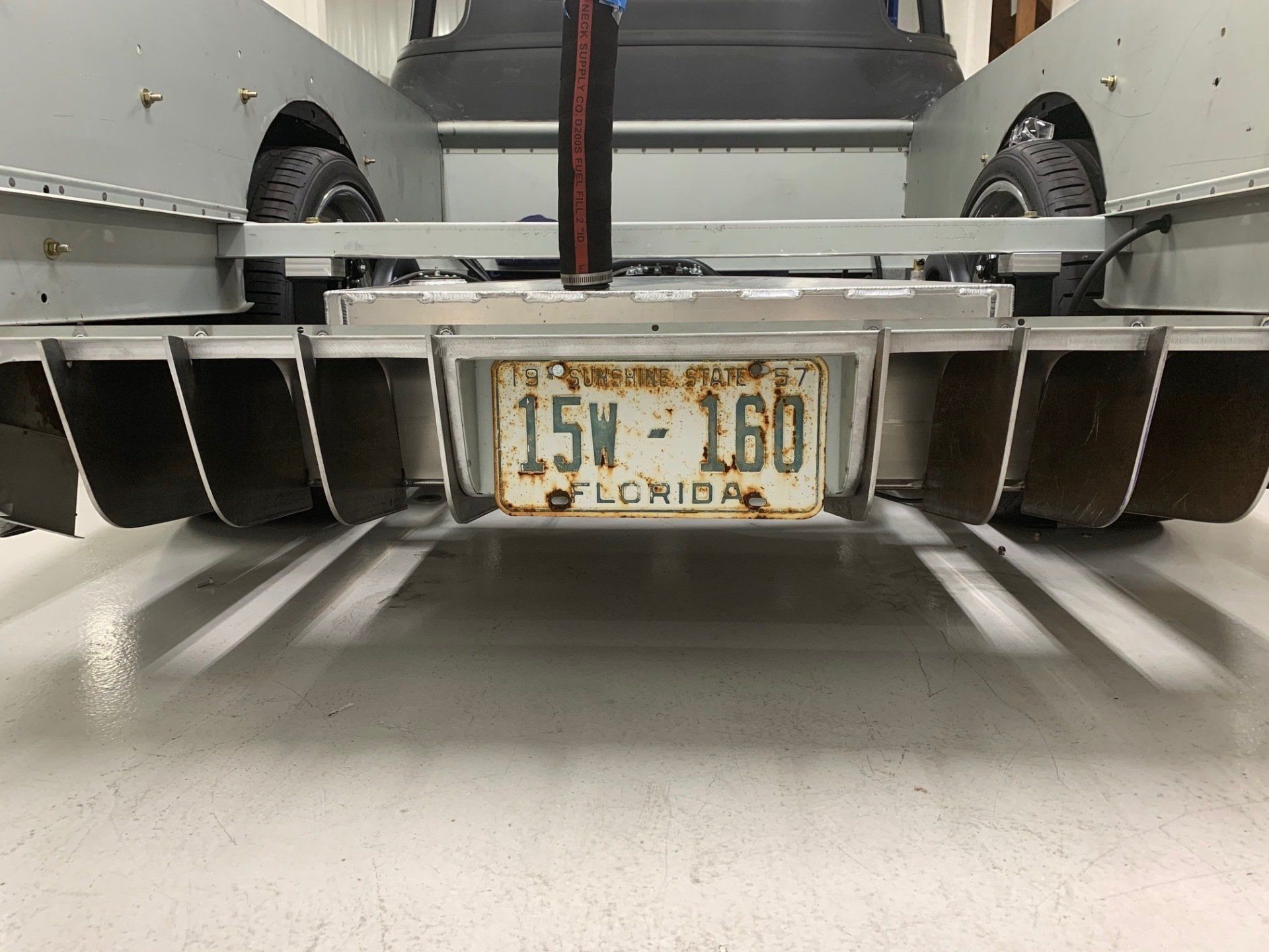 Rear view of a car with a Louisiana license plate and black rear diffuser