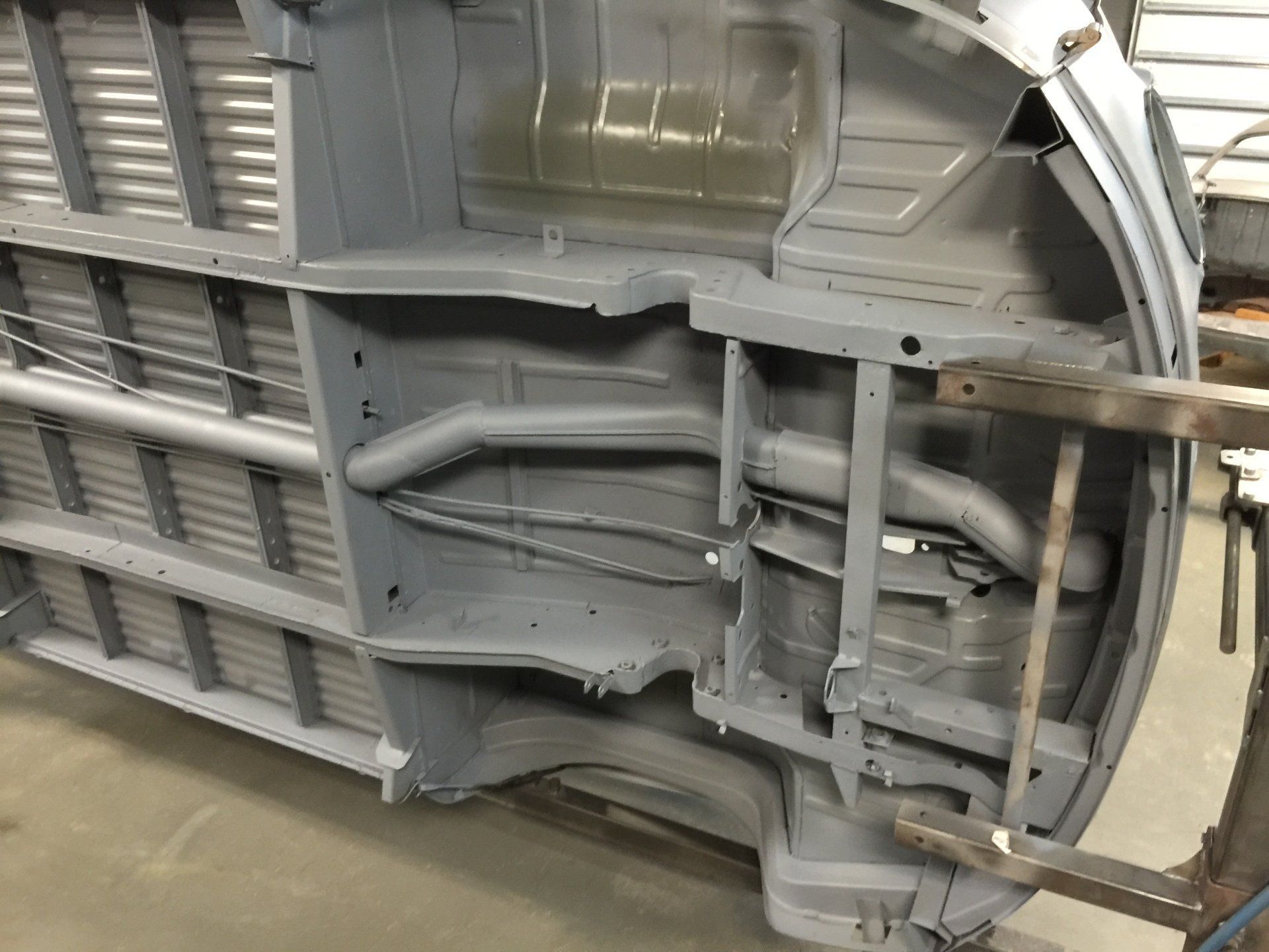 Close-up of a gray metal aircraft landing gear door and internal structure