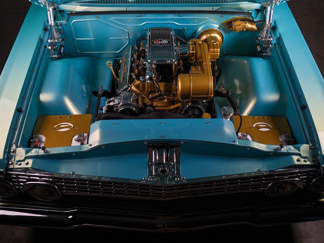 Custom blue classic car engine bay with chrome details and gold accents