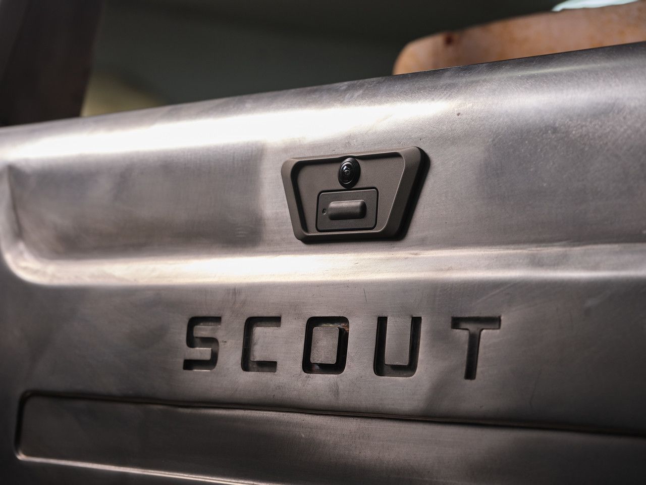 Classic car dashboard with chrome vents, gauges, and steering wheel close-up
