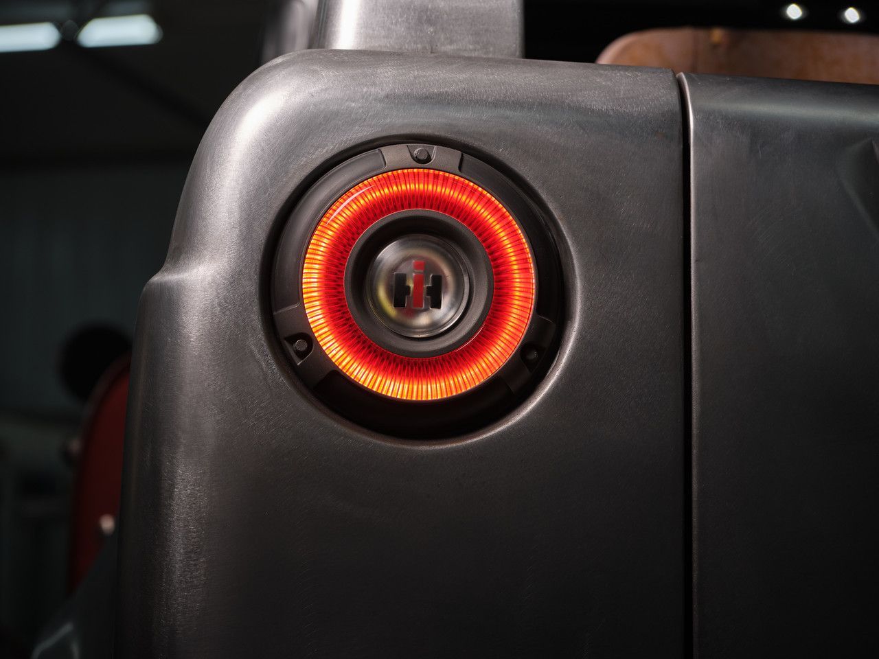 Close-up of a black device with a glowing red circular ring light and central lens