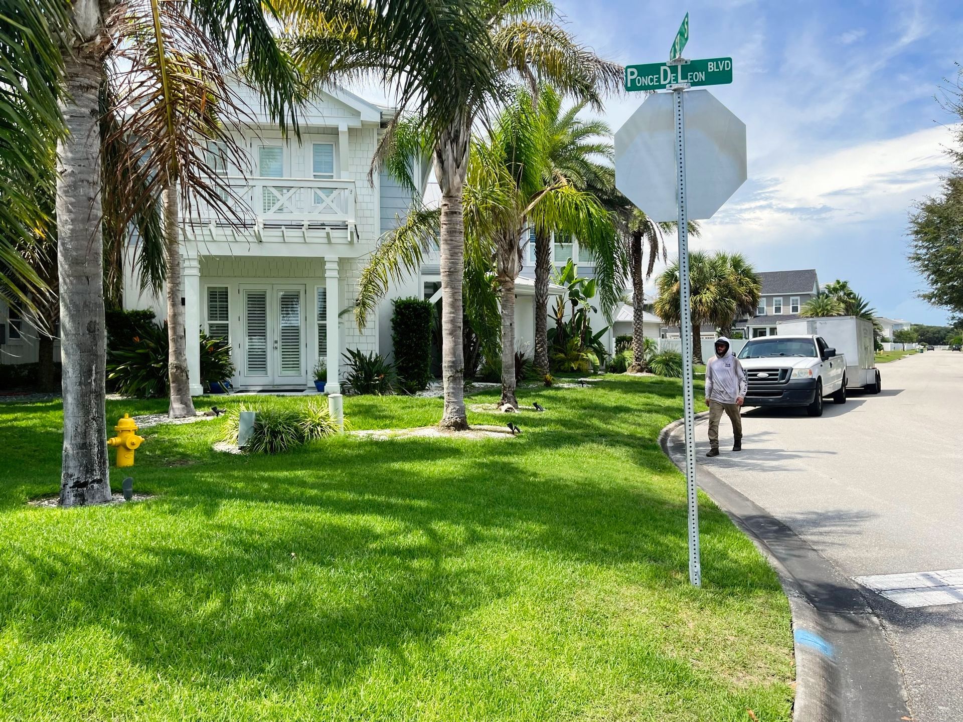 A white house with a fire hydrant in front of it